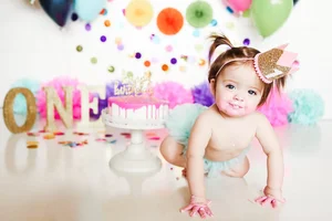 Colorful confetti cake smash session for one year old girl