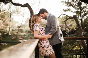 Intimate couple moment on zoo bridge during engagement session