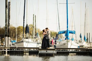 Engagement photo at marina dock with sailboats