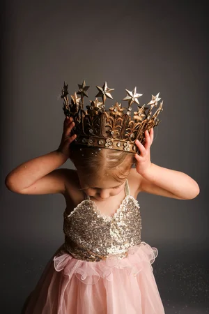 Studio portrait of child wearing crown
