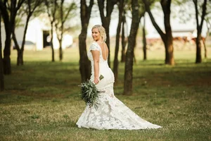 Bride in lace dress in woods at Parker County wedding