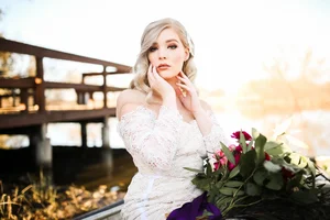 Bride in lace gown on lake dock in DFW area
