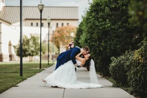 Groom dipping bride on sidewalk at Fort Worth wedding