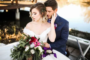 Groom holding bride by lake at Dallas Texas wedding