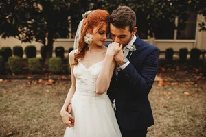 Groom kissing brides hand at DFW area wedding